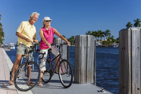Happy Senior Couple on Bicycles By a River