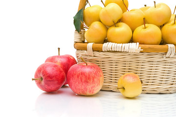 wicker basket with apples on a white background