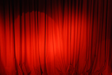 red curtain with spot light theater stage