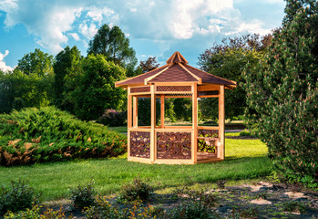 Outdoor wooden gazebo over summer landscape background