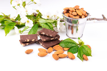 Almonds in a backet with pieces of chocolate with nuts