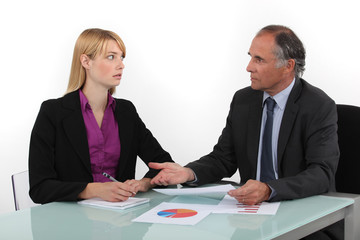 Businesspeople looking at financial results