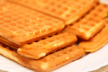Stack of sweet belgian waffles on plate