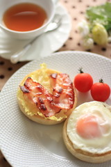 sunny side up and bacon on English Muffin with black tea 