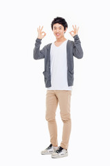 Young asian man showing okay sign.