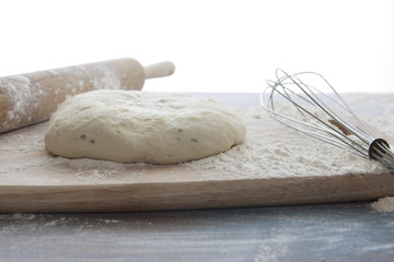 Pizza dough on cutting board.
