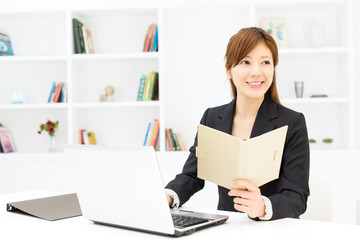  Beautiful young businesswoman working in office