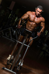 Fototapeta na wymiar male bodybuilder using the elliptical machine