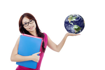 Fototapeta premium Beautiful female student holds globe isolated on white