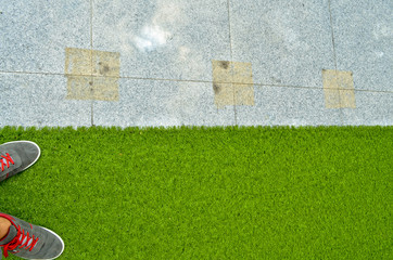 Artificial grass and white marble background
