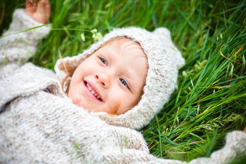 little girl lying on the grass