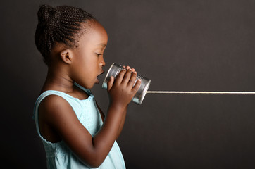 African girl communicating via a tin