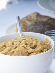 Breakfast buffet table setting with cereal and pastries