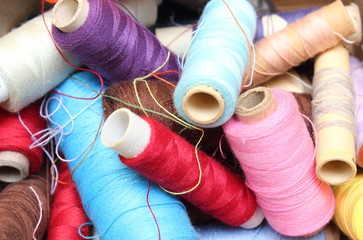 Tangled spools of sewing thread