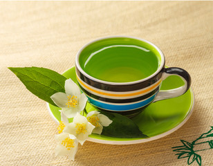 Cup of jasmine tea and jasmine flowers