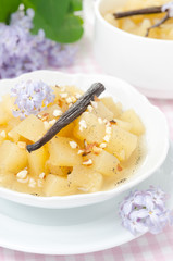 closeup of compote of apples and pears with vanilla and lilac