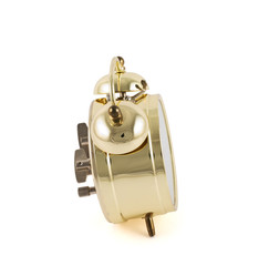 Golden mechanical alarm clock isolated