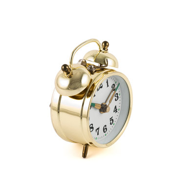 Golden mechanical alarm clock isolated