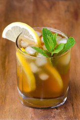 glass of ice tea with lemon and mint close-up