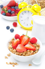 Granola with fresh berries for breakfast and alarm clock