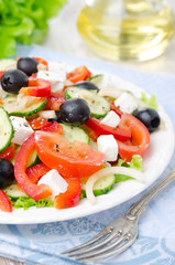 Fototapeta na wymiar Greek salad with feta cheese, olives and vegetables, closeup