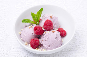 ice cream with raspberries in a bowl