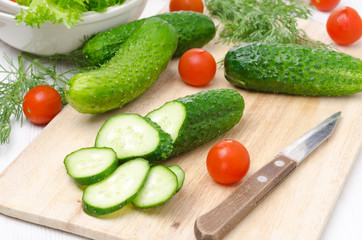 ingredients for salad - fresh cucumbers, tomatoes and herbs
