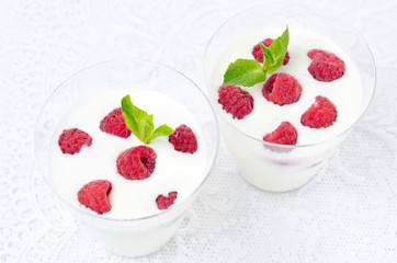 panna cotta with fresh raspberries in a glass top view
