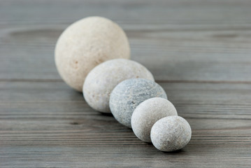 Five river stones on a table