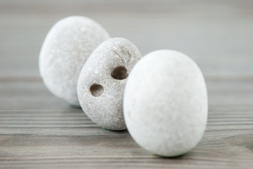 Three river stones on a table