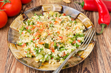 salad with bulgur, zucchini, tomatoes and parsley on the plate