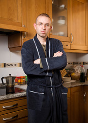 Man in pajamas in his kitchen