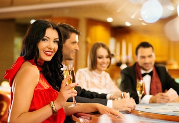 Group of young people playing poker in a casino