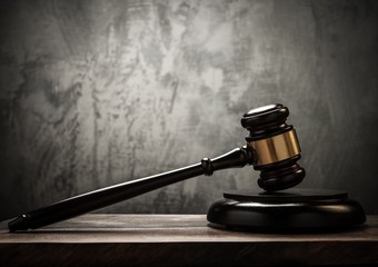 Judge's hammer on wooden table