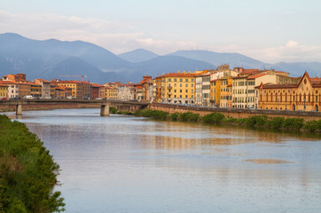 Fototapeta na wymiar River Arno floating through the medieval city of Pisa.