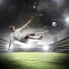 Fototapeta na wymiar football player striking the ball