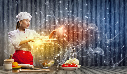 Asian female cooking with magic