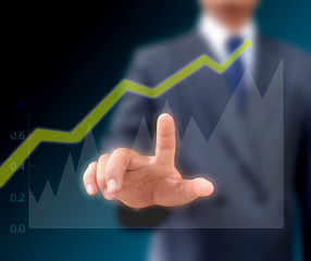 Businessman watching the upward trend of a graphic chart.