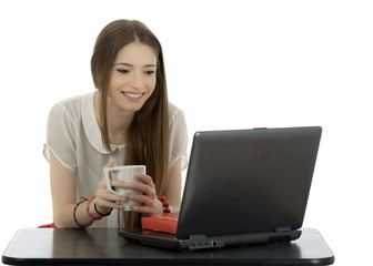 Young businesswoman at an office desk with a cup of coffe isolat