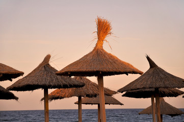 Beach umbrellas at sunset