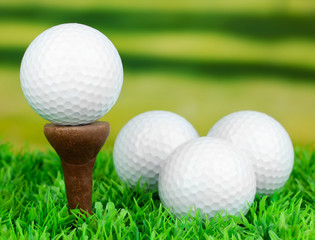 Golf balls on grass outdoor close up
