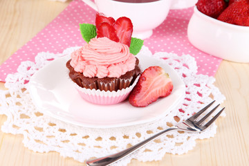 Beautiful strawberry cupcake on dining table close-up