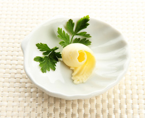 Butter curl on plate, close up