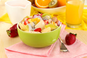 Useful fruit salad of fresh fruits and berries in bowl