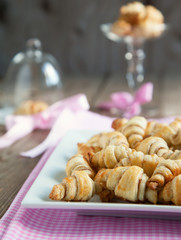 Rugelach with cinnamon and sugar filling in bowl on the wooden t