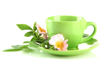 Cup of herbal tea with hip rose flowers, isolated on white