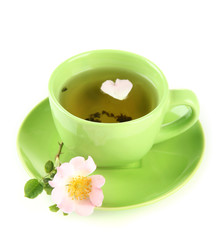 Cup of herbal tea with hip rose flower, isolated on white