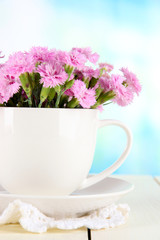 Many small pink cloves in cup