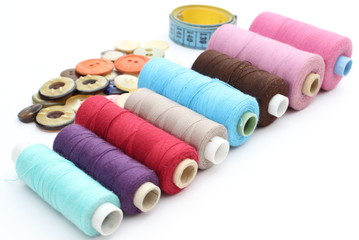 Colorful spools of thread, tape measure and buttons
