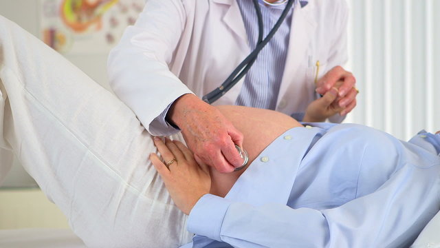 Doctor Examining preganct woman's belly